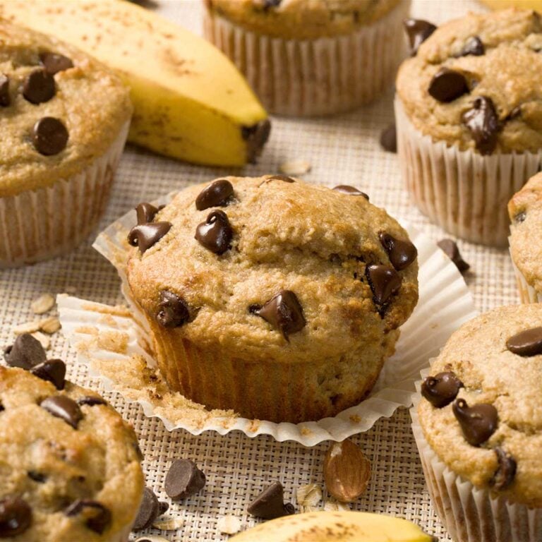 A gluten-free banana chocolate chip cottage cheese muffin with the wrapper pulled off.