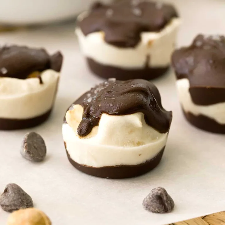 A close-up of a viral peanut butter banana cluster next to several chocolate chips.