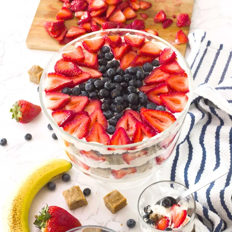 Top view of a patriotic gluten-free banana cake berry trifle with a blueberry star, strawberries and bananas.