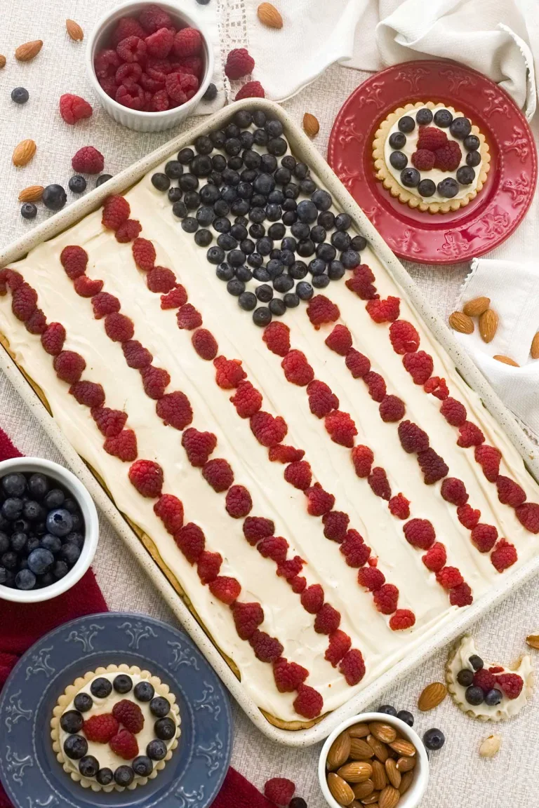 How to make a delicious gluten-free flag fruit pizza w/ almond flour. Smooth cream cheese frosting all naturally sweetened w/ maple syrup.