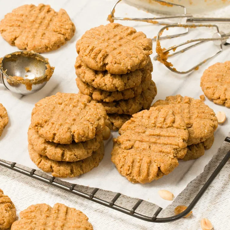 The best-tasting gluten-free peanut butter cookies with peanut butter, almond flour, maple syrup, coconut sugar, butter, and vanilla extract.