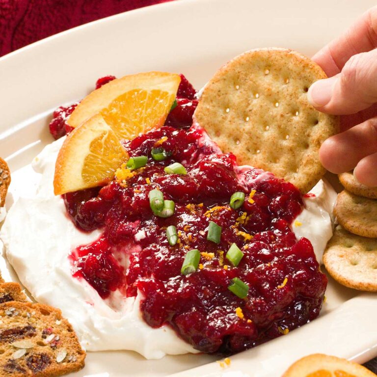 Cranberry orange dip with cottage cheese on a cracker.