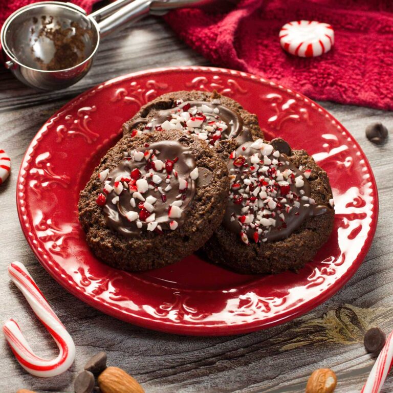 Three gluten-free chocolate peppermint cookies on a red plate.