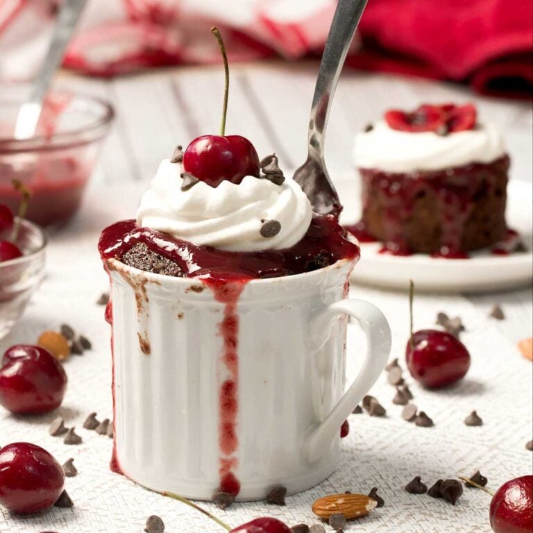Cherry Chocolate Black Forest Mug Cake on a kitchen counter.
