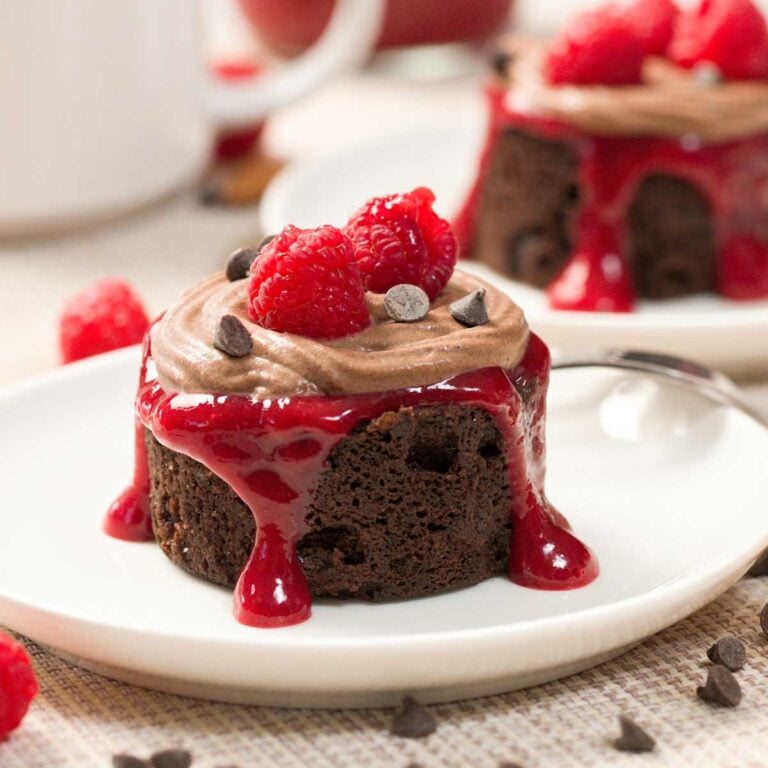 Gluten-Free Cherry Chocolate Raspberry Mug Cake on a white plate.