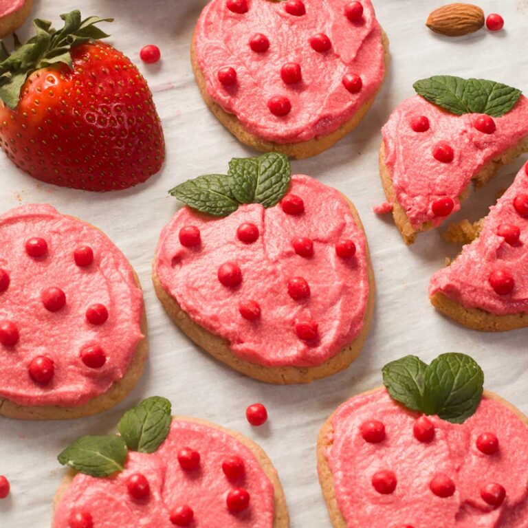 Gluten-Free Freeze Dried Strawberry Frosted Cookies on parchment paper.