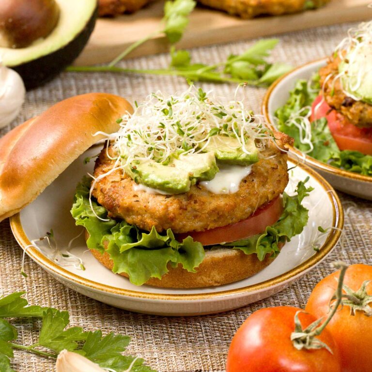 Ground chicken patty with lettuce, tomato, avocado, and sprouts.