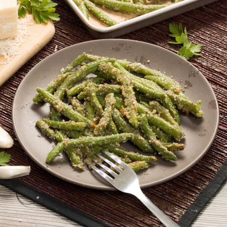 Roasted green beans on a plate.