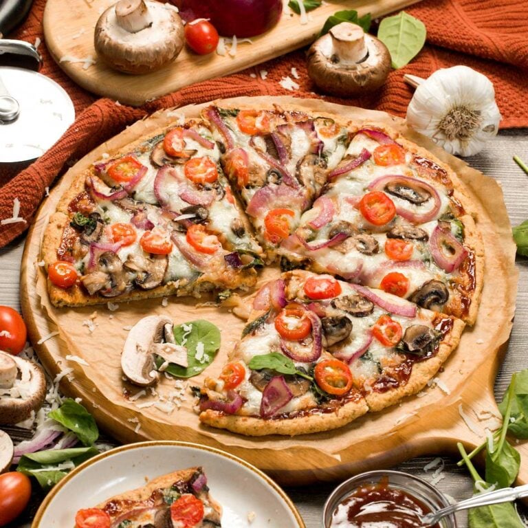 BBQ chicken crust pizza on a pizza board.