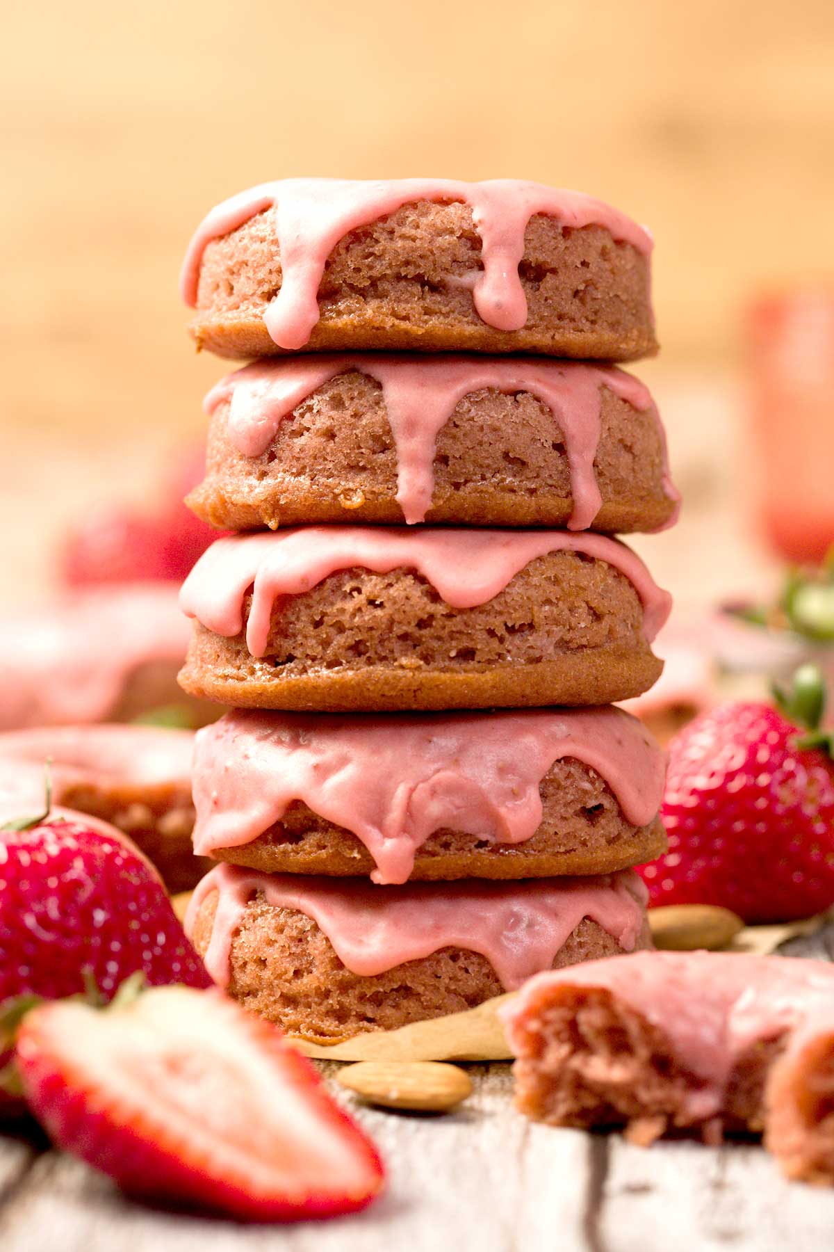 Gluten-Free Strawberry Glazed Donuts on a parchment paper.