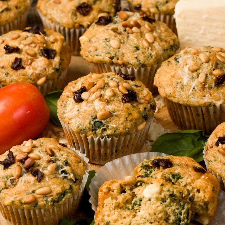 Gluten-free feta spinach muffins on a cutting board.
