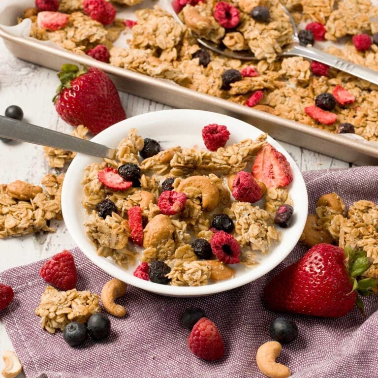 MIxed berry granola with freeze-dried berries on a cookie sheet.