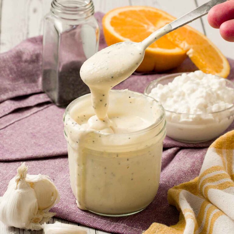 Spoonful of Panera poppyseed dressing in a jar.