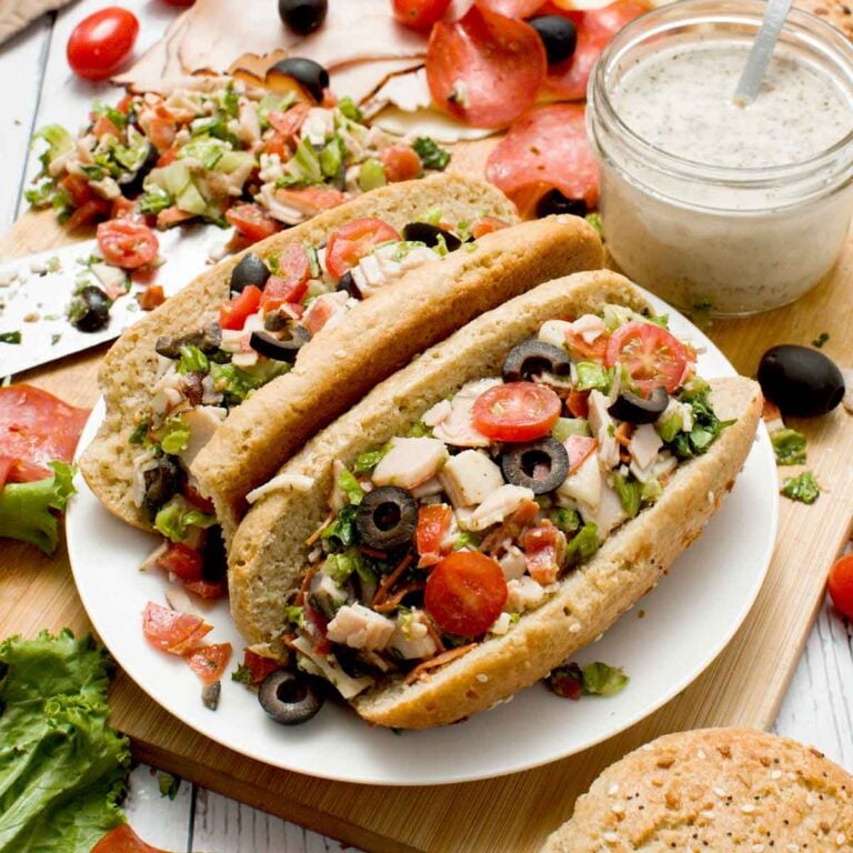 Two chopped Italian sandwiches on a plate.