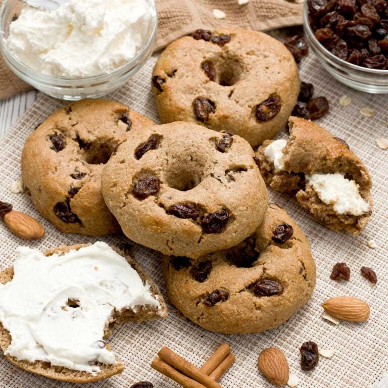 A stack of cinnamon raisin bagels with an egg wash.