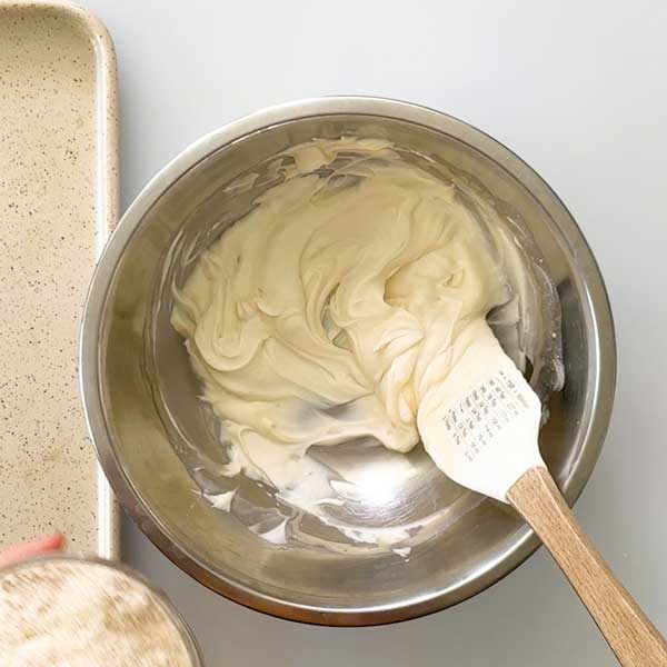 Stirring the wet ingredients for the muffin dough in a bowl.