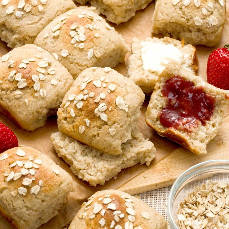 Batch of oat flour dinner rolls with greek yogurt on a parchment paper.