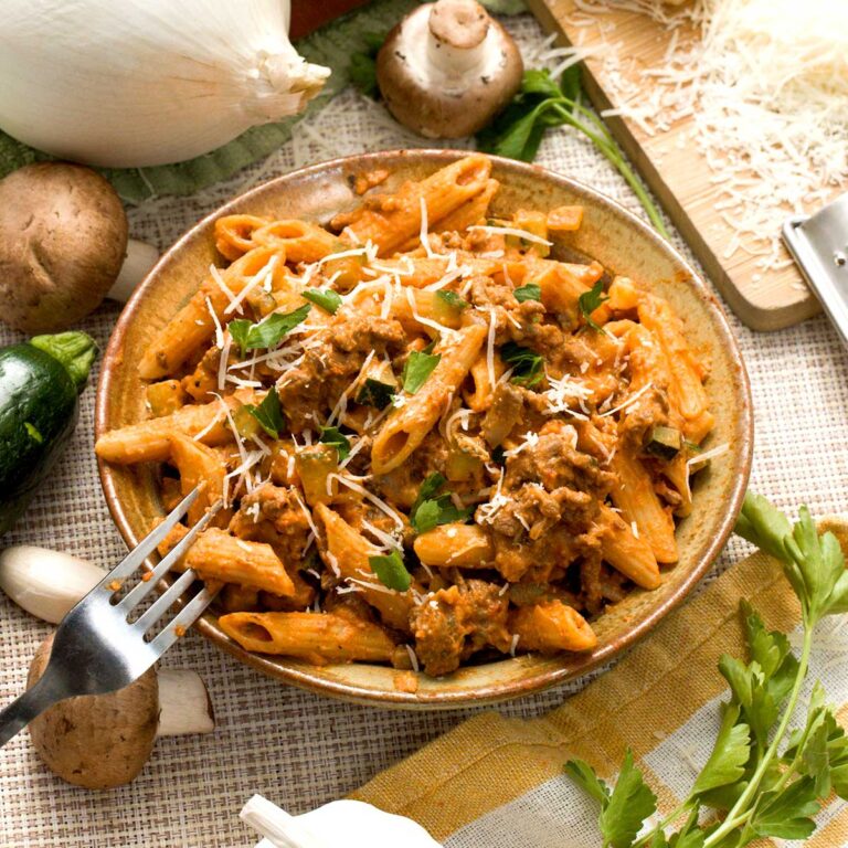 A bowl of protein pasta Bolognese with mushrooms, zucchini and ground beef.