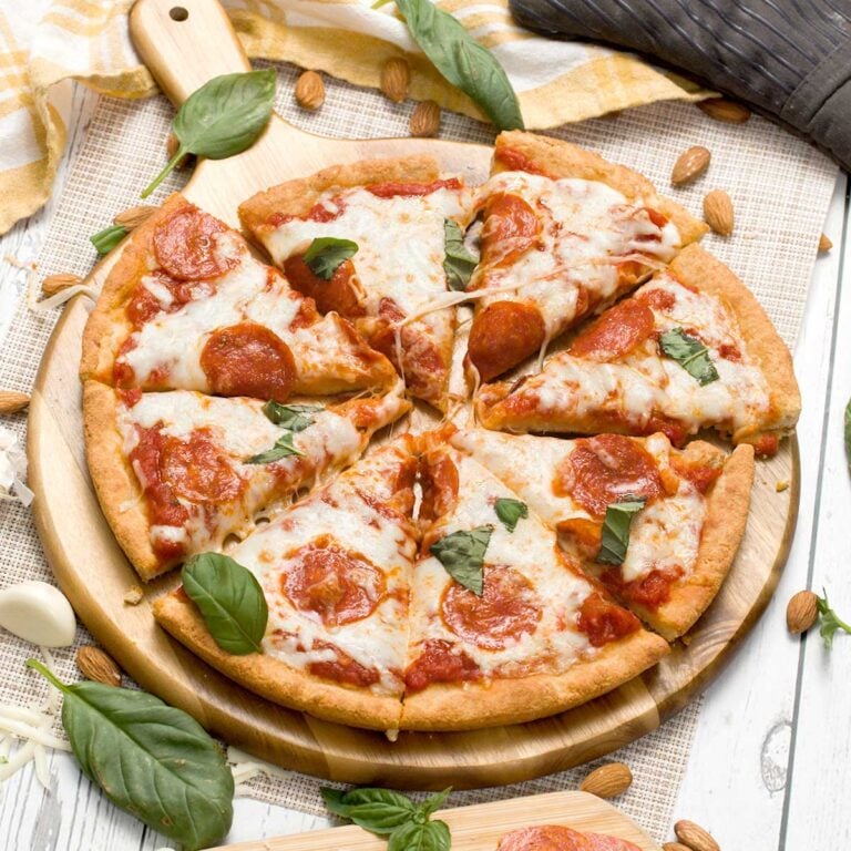 A gluten-free cottage cheese pizza crust made with almond flour and topped with pepperoni and cheese.
