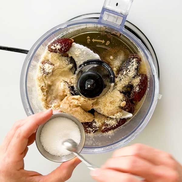 All the ingredients added to a food processor for the date caramel.
