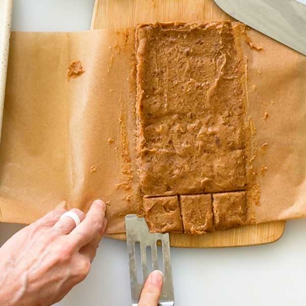 Cutting the frozen caramels into squares.