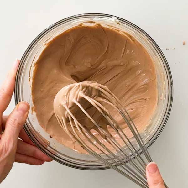 Whisking all the ingredients together in a mixing bowl.