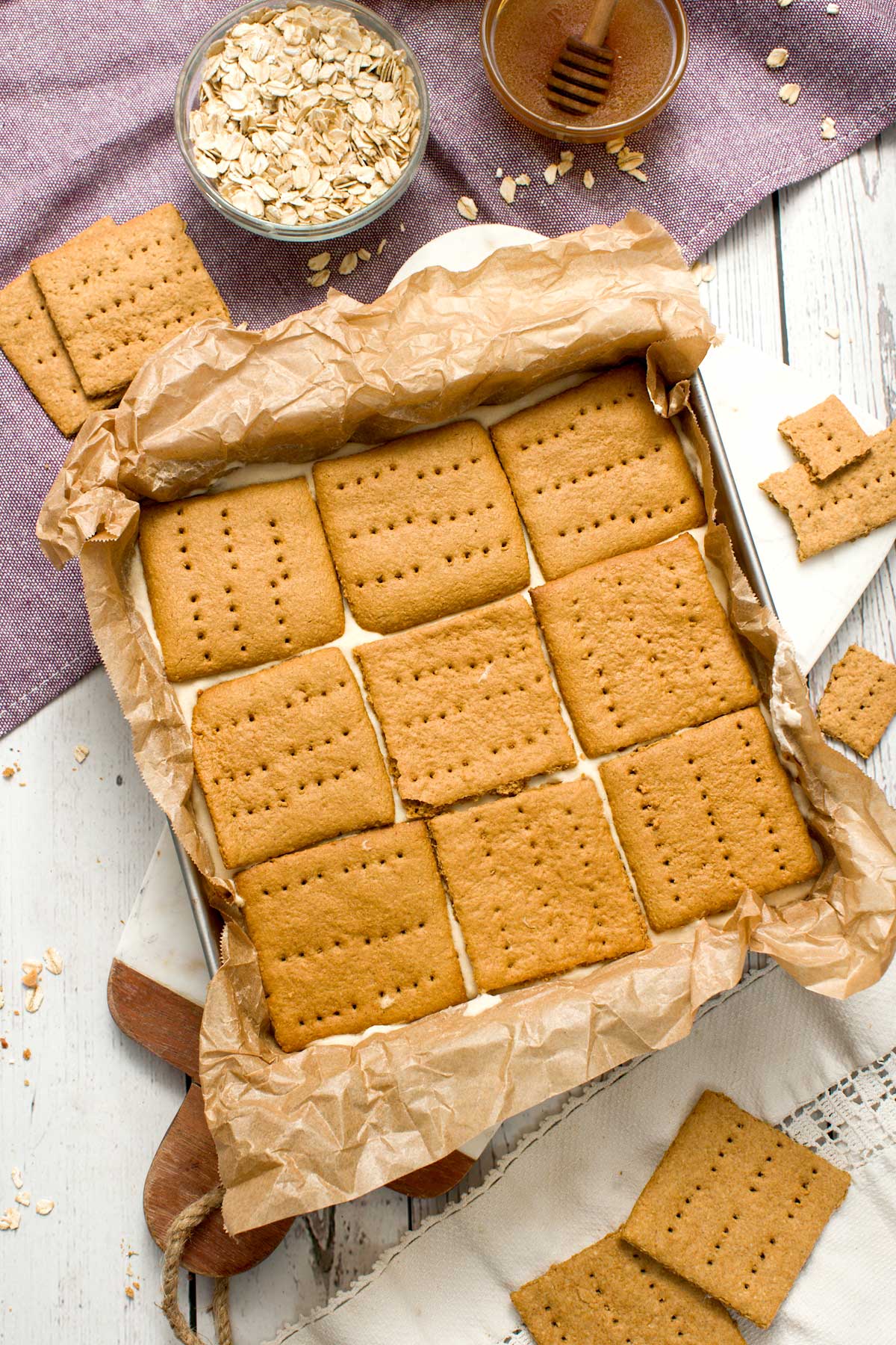 A square pan with nine frozen s'mores ice cream sandwiches.