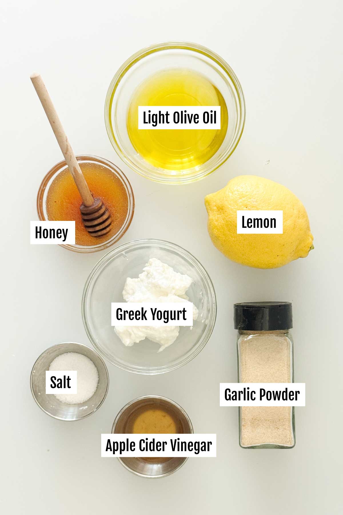 All the ingredients you need to make honey lemon vinaigrette with greek yogurt.