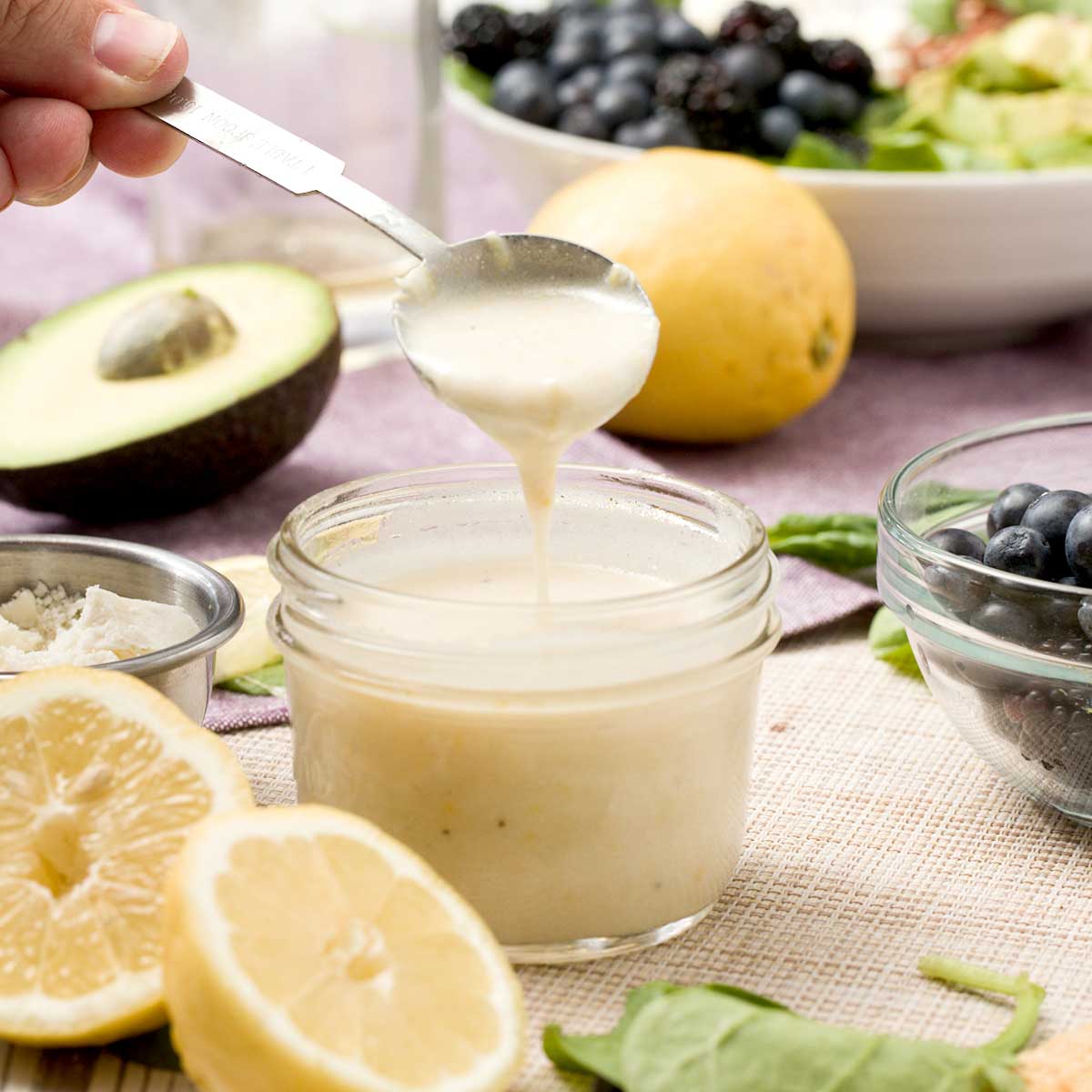 A jar of honey lemon vinaigrette with greek yogurt.