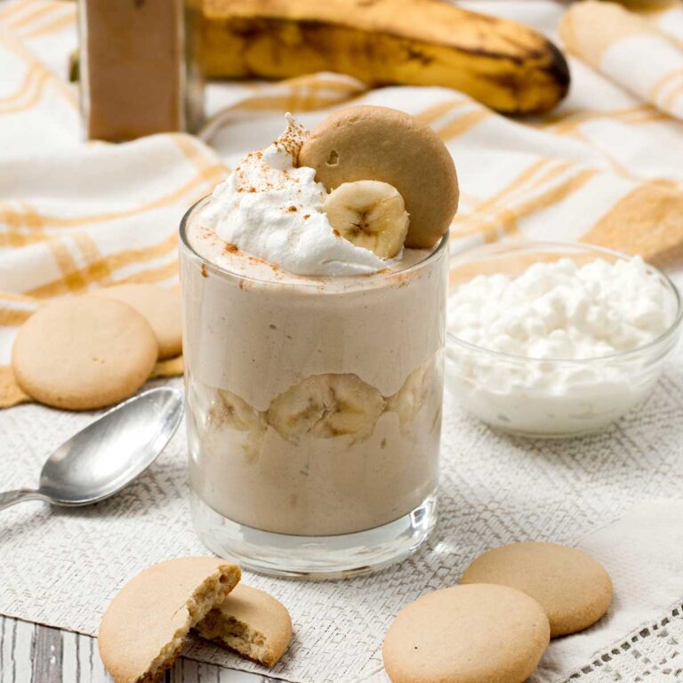 A glass jar with protein banana pudding with cottage cheese.