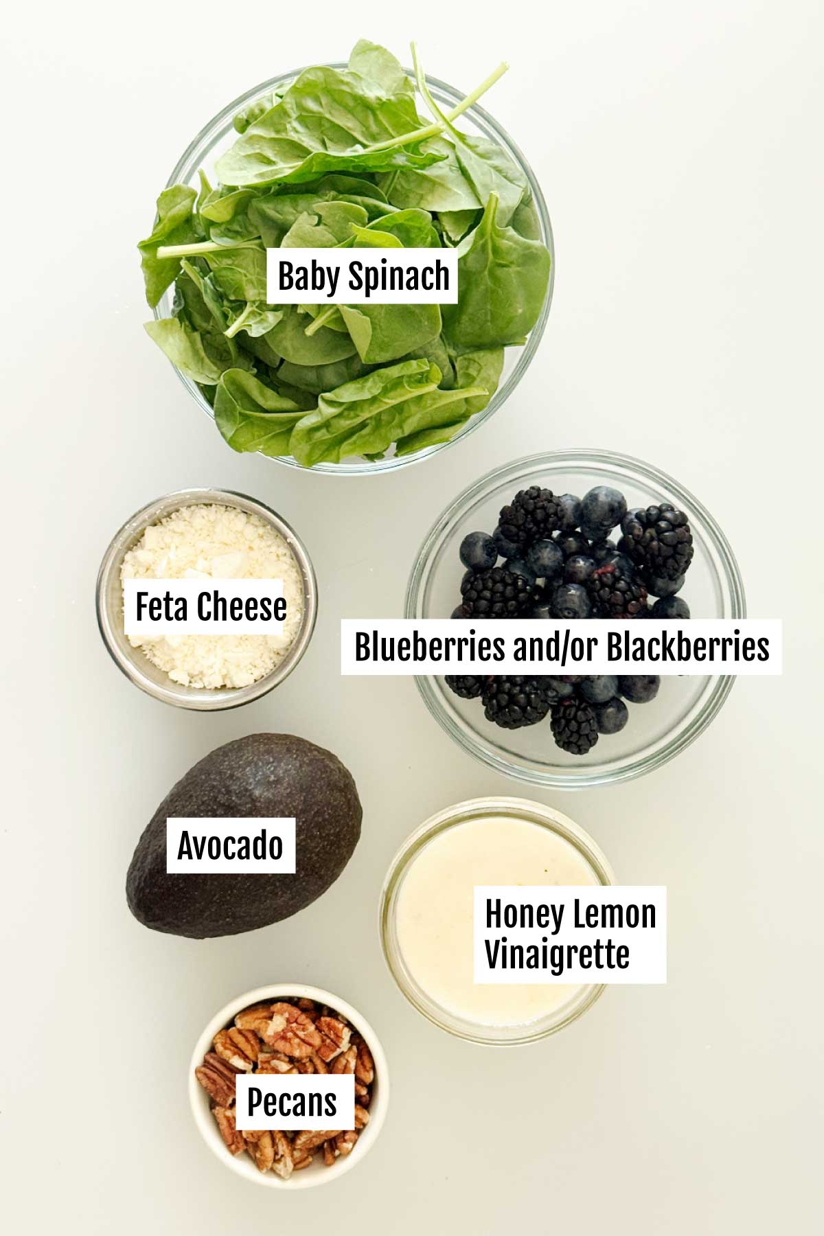All the ingredients you need to make spinach blueberry salad with feta, avocado & creamy honey lemon dressing.