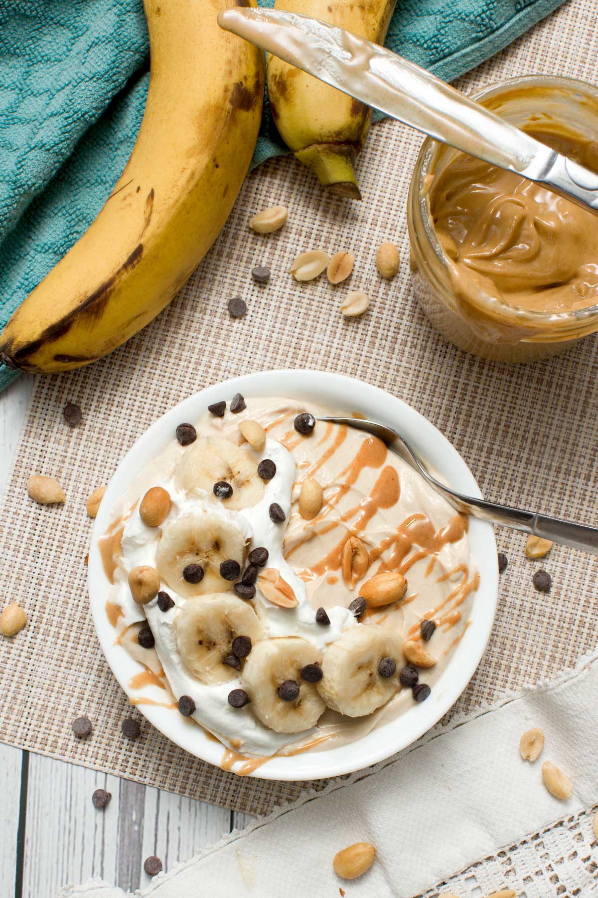 Peanut butter Greek yogurt protein bowl with banana slices and chocolate chips.