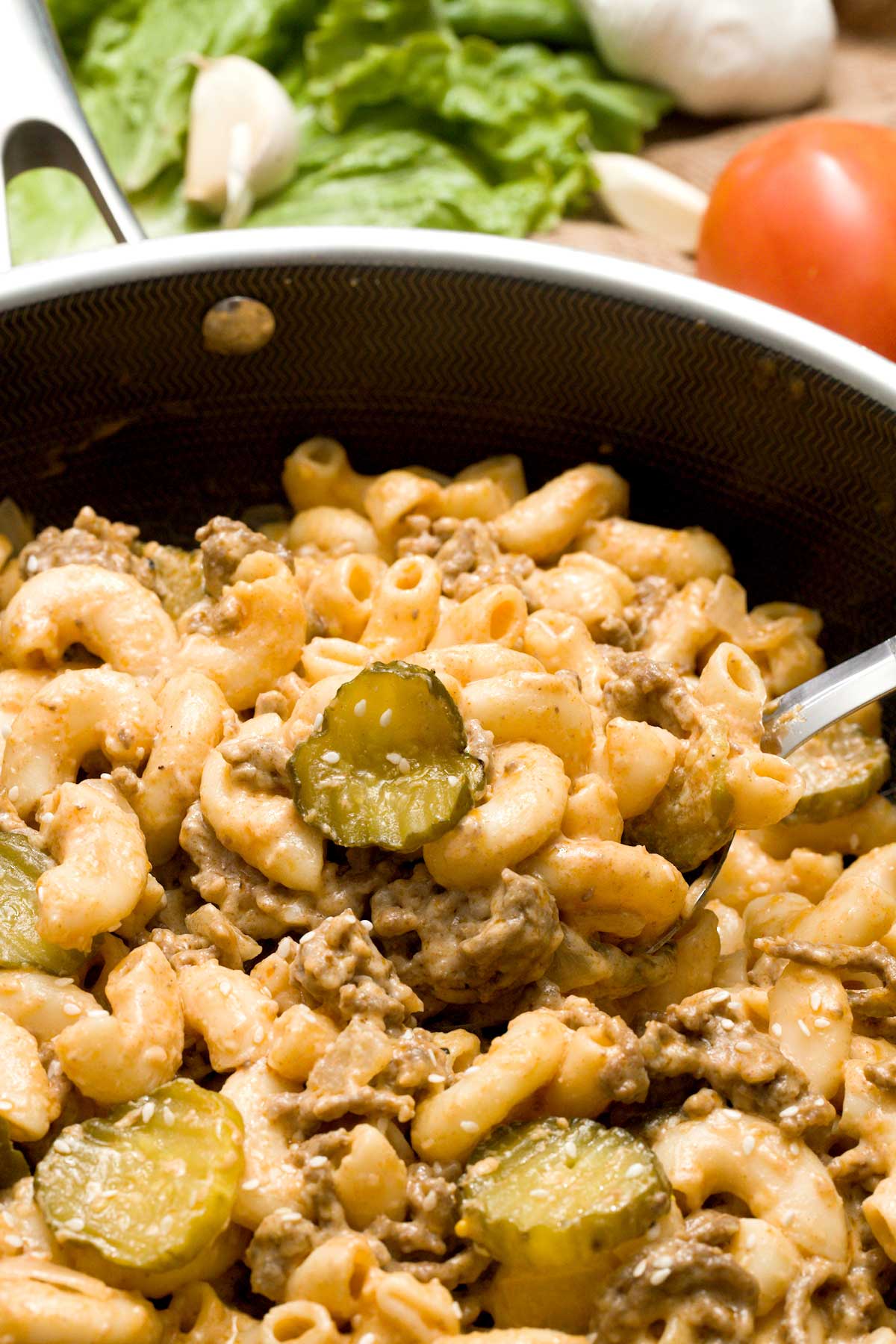 High protein big Mac pasta with pickles and Greek yogurt cheese sauce in a skillet.