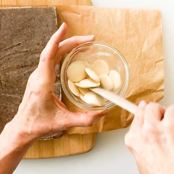 Adding the coconut oil to the white chocolate in a microwave safe bowl.