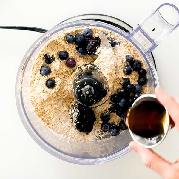 Adding all the protein bar ingredients to a food processor.