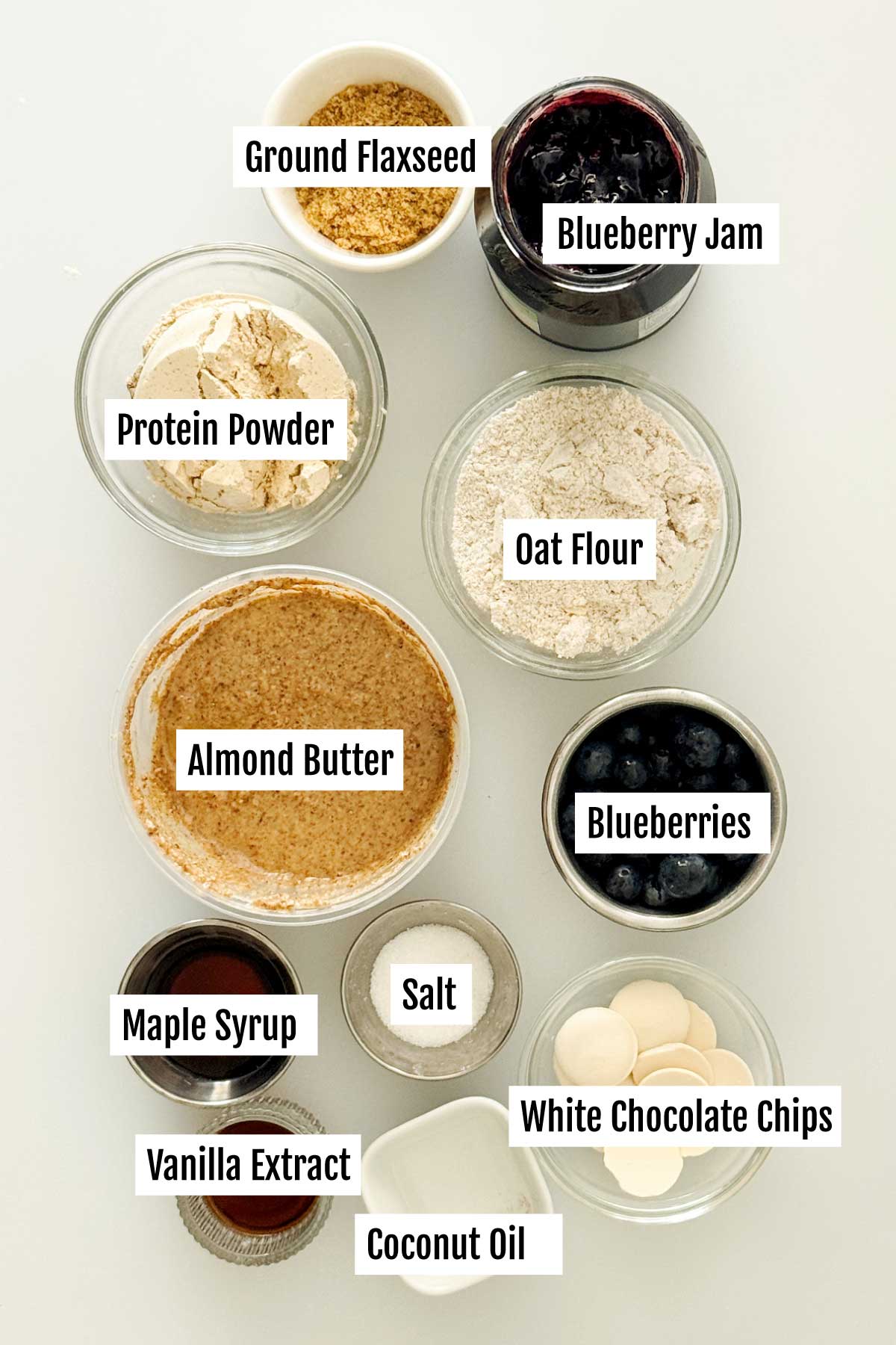 All the ingredients you need to make gluten-free blueberry protein bars with a white chocolate drizzle.