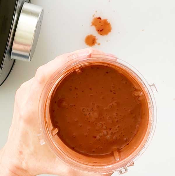 The blended cherry balsamic vinaigrette in a blender cup.
