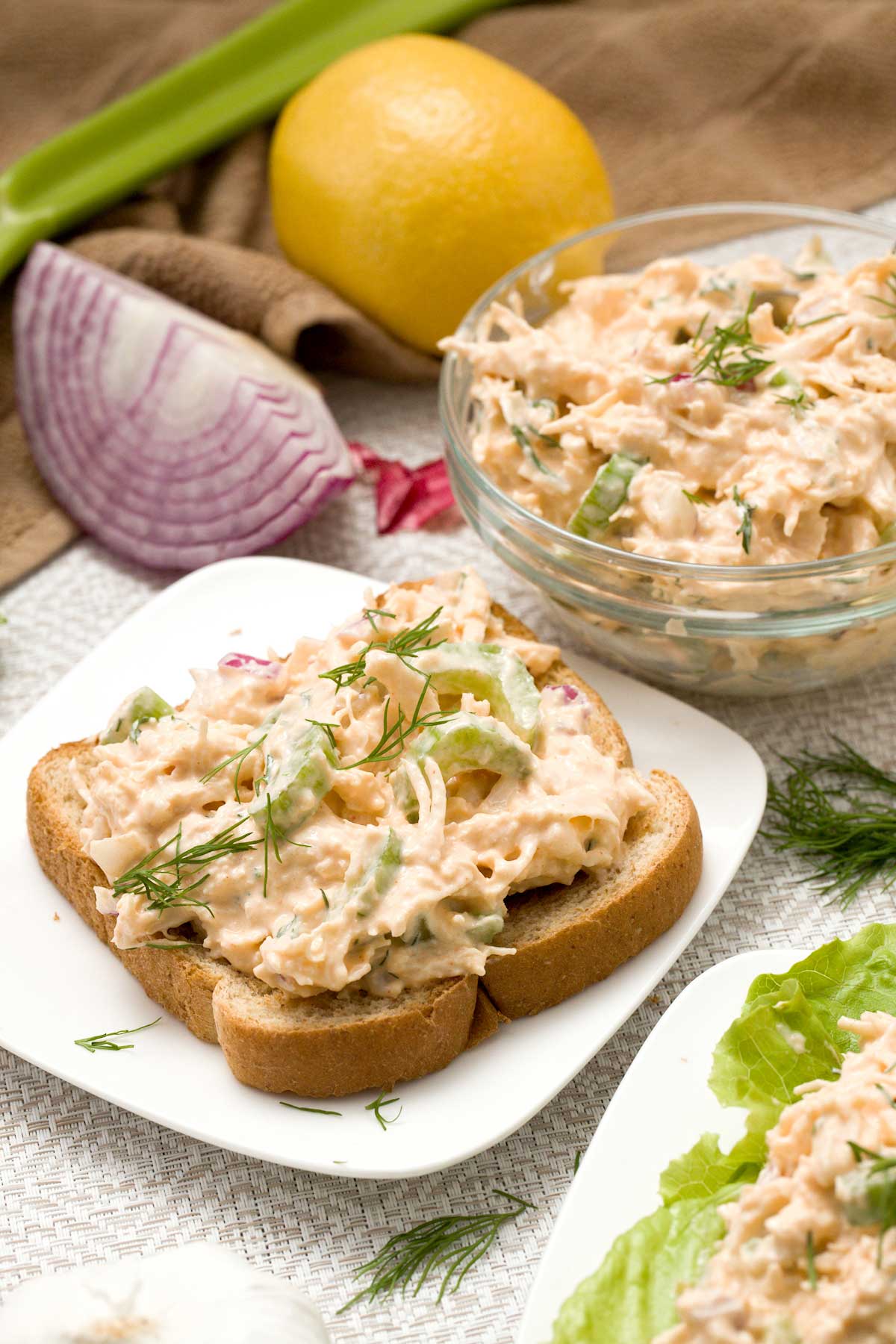 A piece of toast and bowl of protein cottage cheese chicken salad with celery.