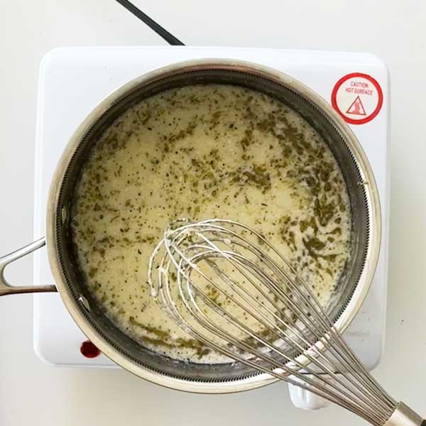 Stirring in the cornstarch mixture to thicken the sauce.