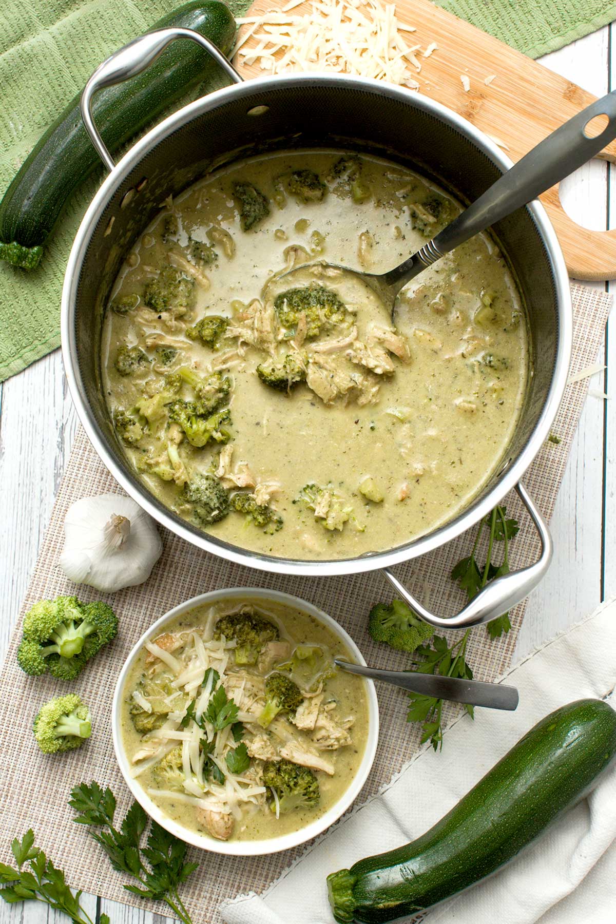 A Hexclad hybrid pot with creamy zucchini broccoli chicken soup and a bowl.