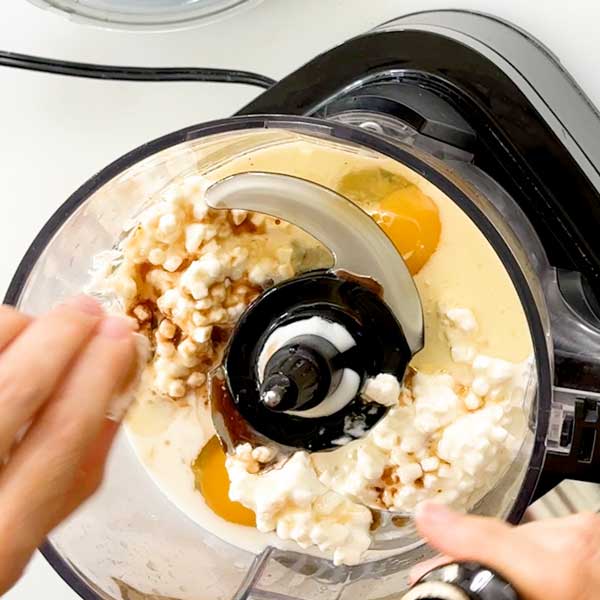 Adding the wet ingredients to the food processor.