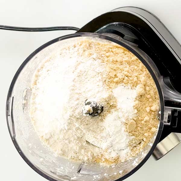 Adding the dry ingredients to the waffle batter.