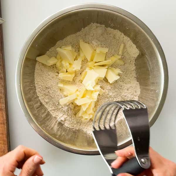 Adding the cold butter to the dry mixture