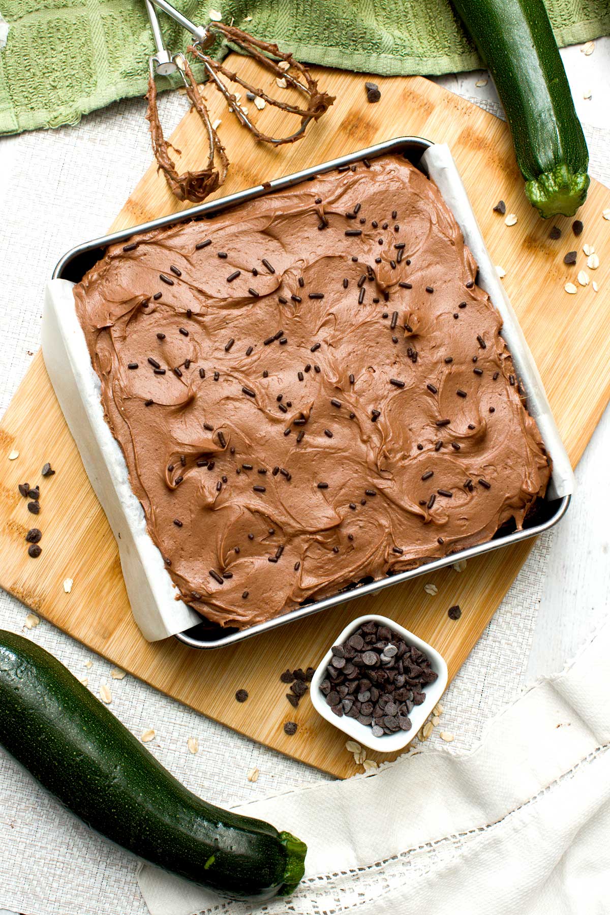The top view of a gluten-free chocolate zucchini cake with cream cheese frosting.
