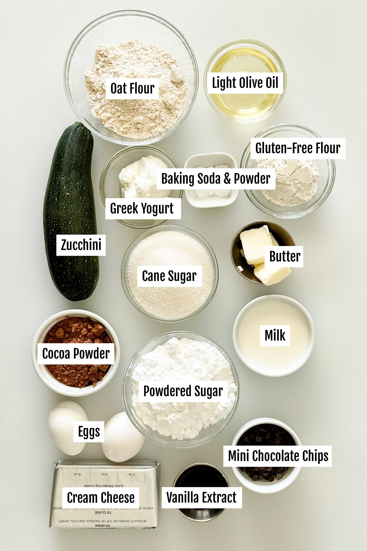 All the ingredients needed to make a gluten-free chocolate zucchini cake with chocolate cream cheese frosting.