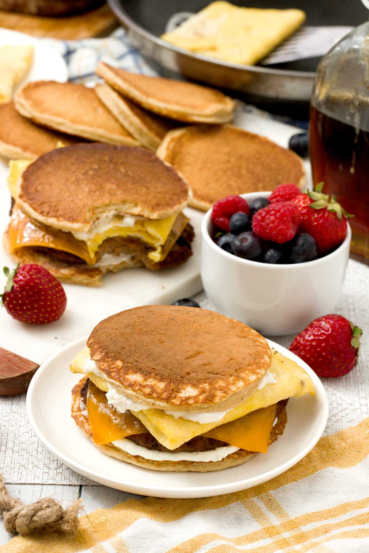 Several griddle sandwiches with eggs and cheese and pancakes.