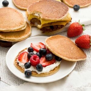 An open-face, gluten-free protein pancake sandwich with oat flour and filled with cream cheese and berries.