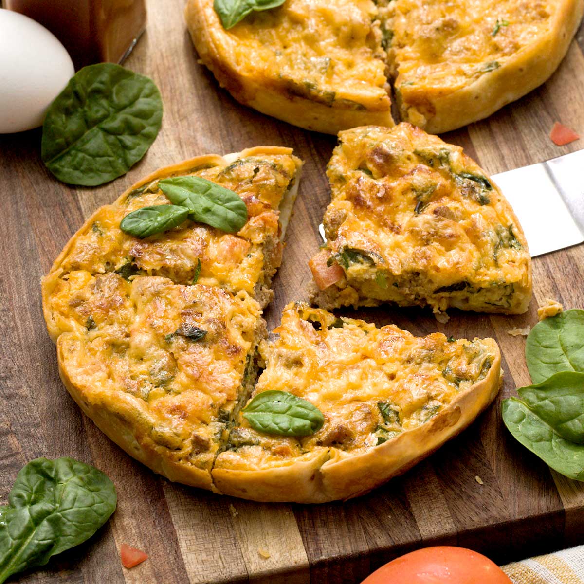 A high-protein tortilla quiche with vegetables and ground turkey and melted cheese on top.