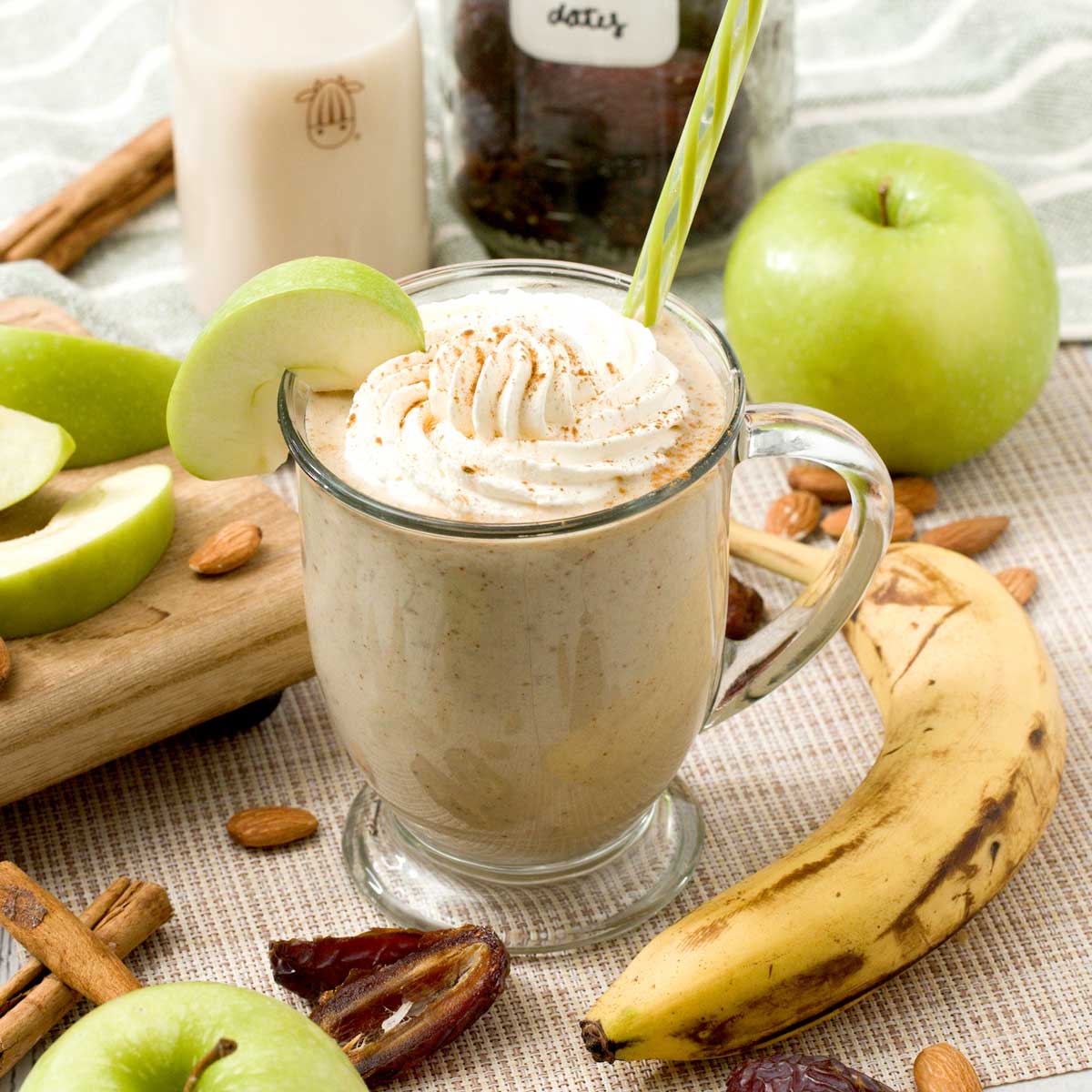 A caramel apple protein smoothie with dates, almond butter, and Greek yogurt in a glass.