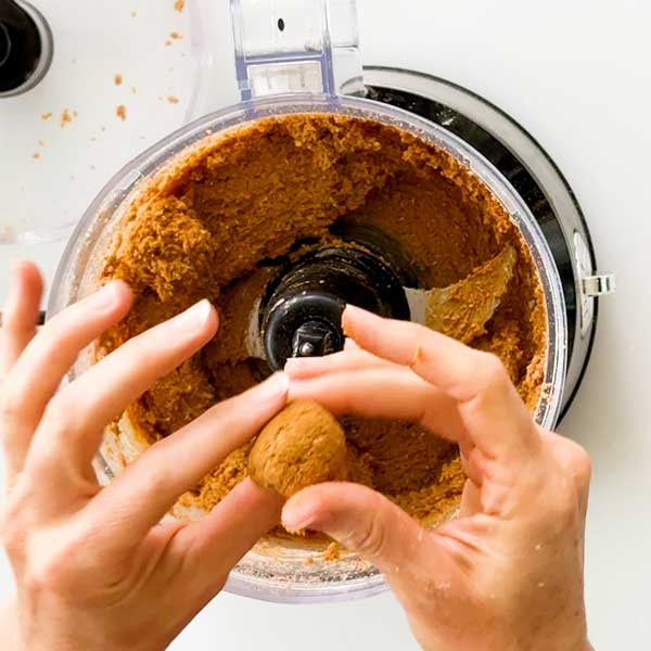 The dough is dry enough to roll into a ball in your hands but is still slightly tacky.